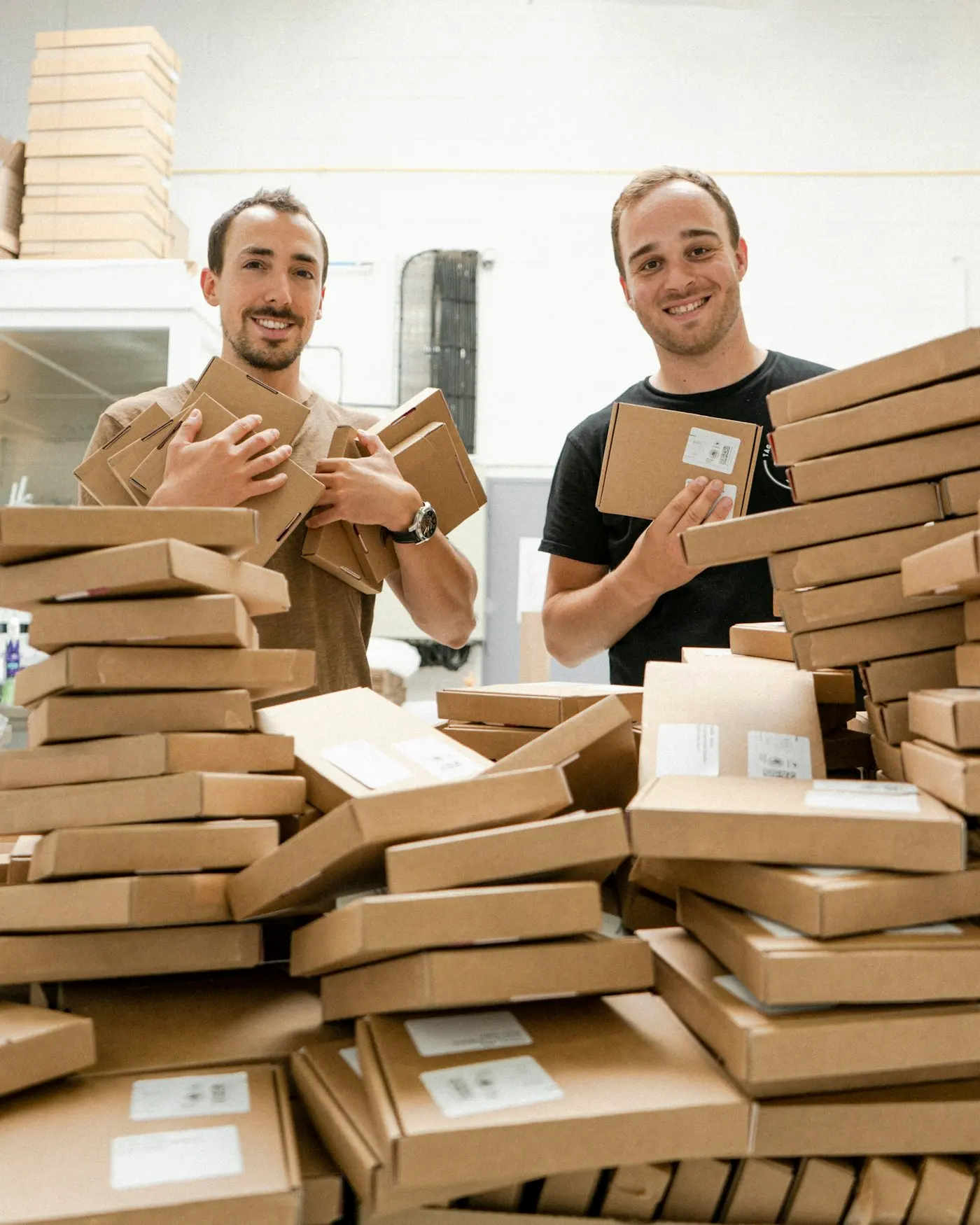 Two people preparing many orders in boxes