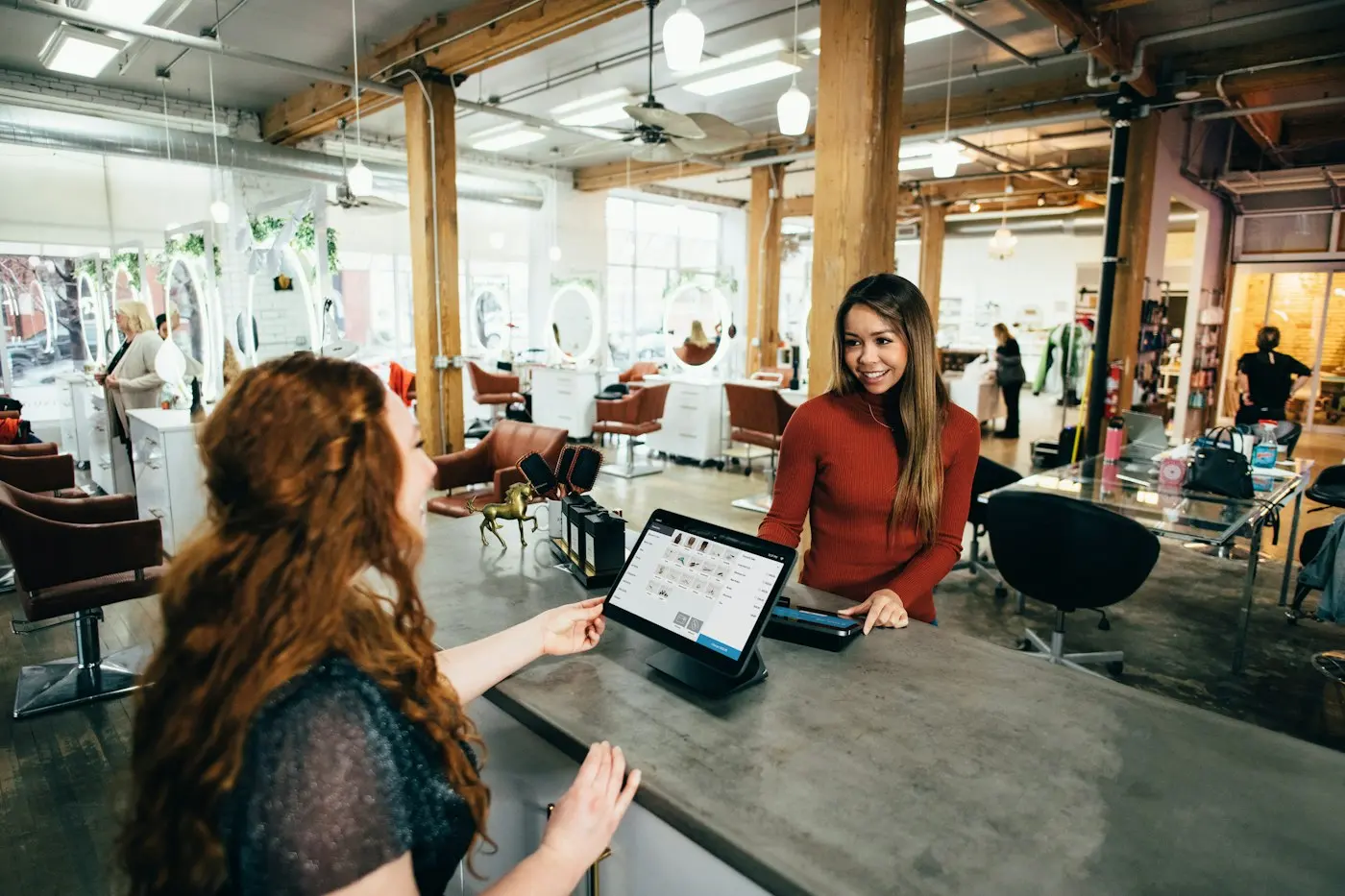 Employee serving a customer at a shop counter