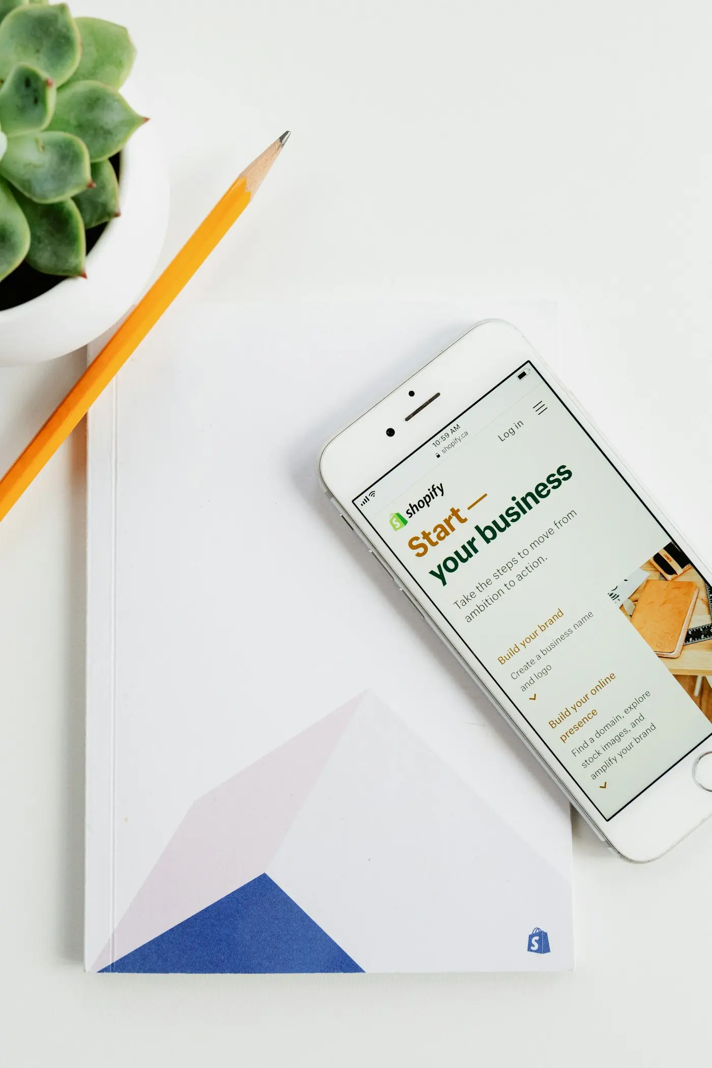 Phone showing the Shopify home page to create a store