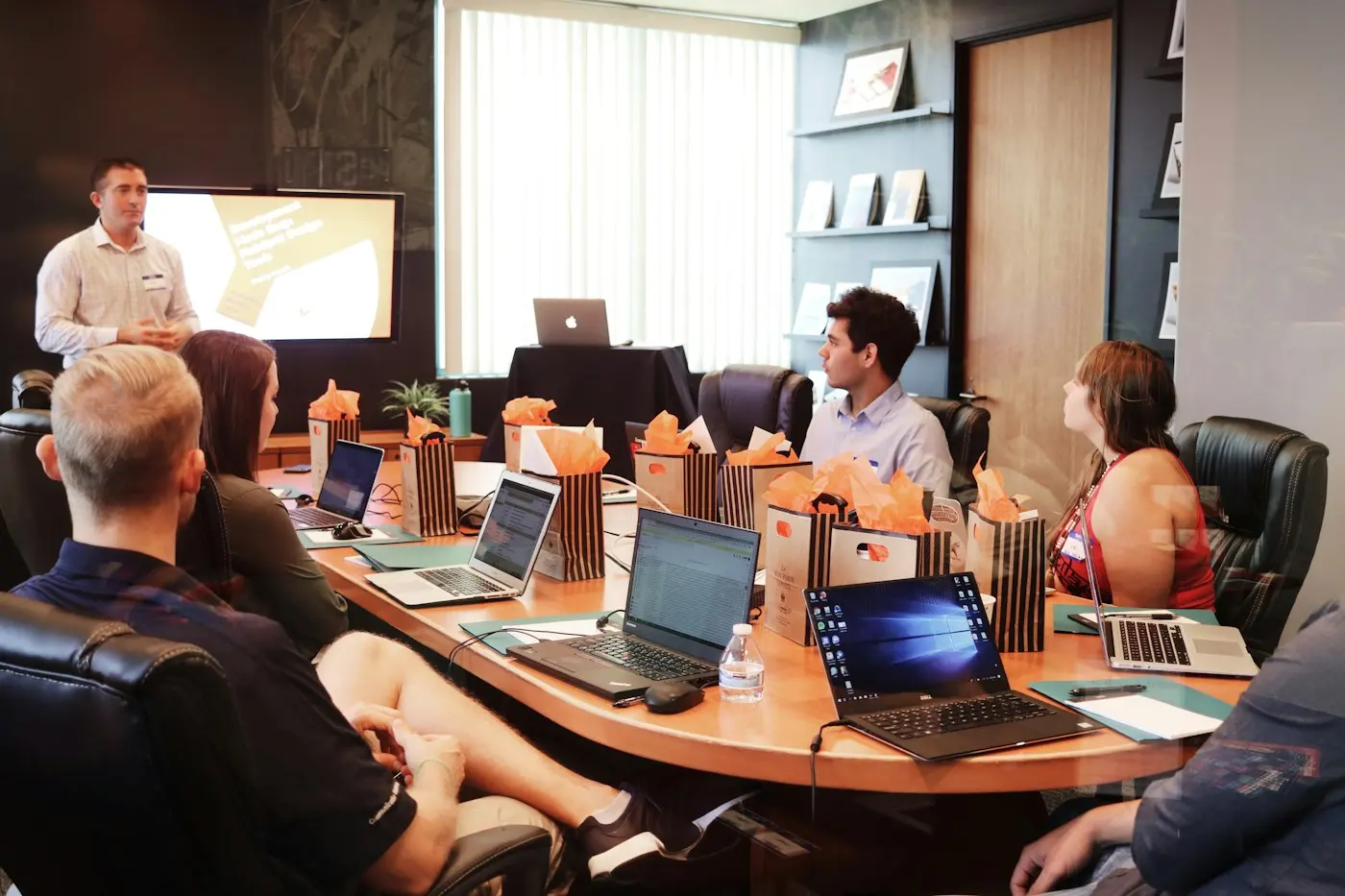 Team gathered around a table with their laptops
